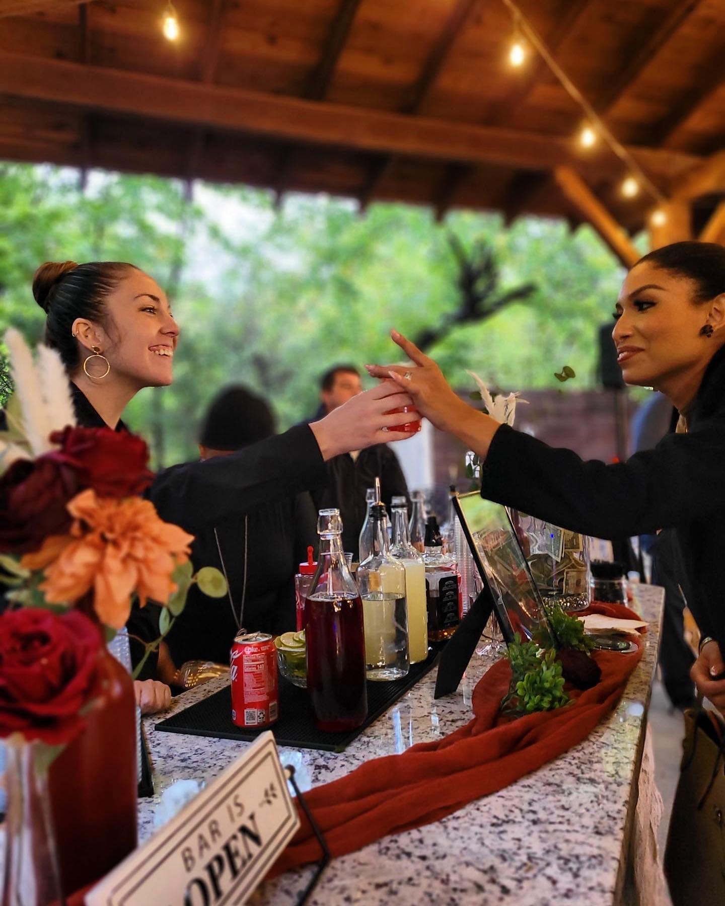 wedding guest taking drink from bar