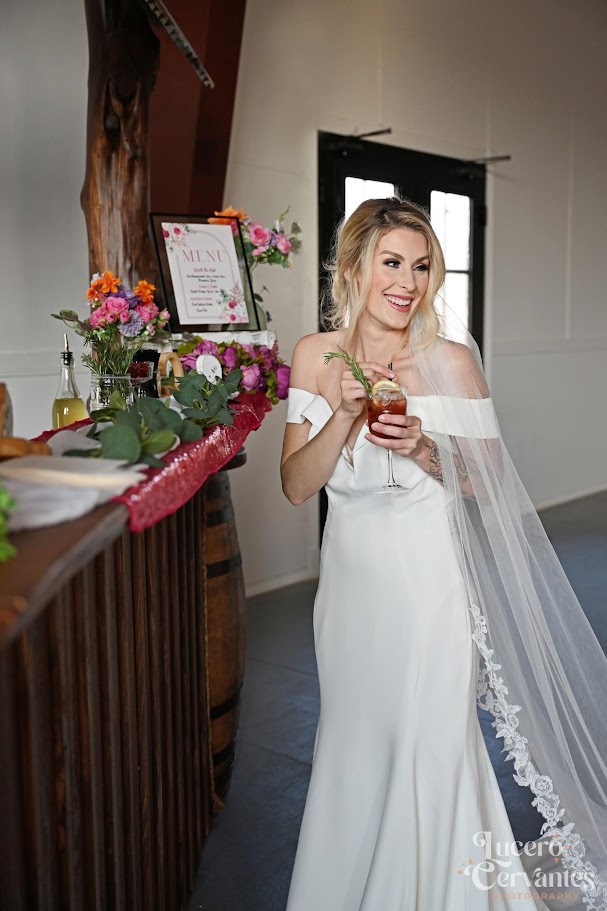 bride holding cocktail at wedding