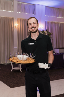 event staff holding tray of appetizers